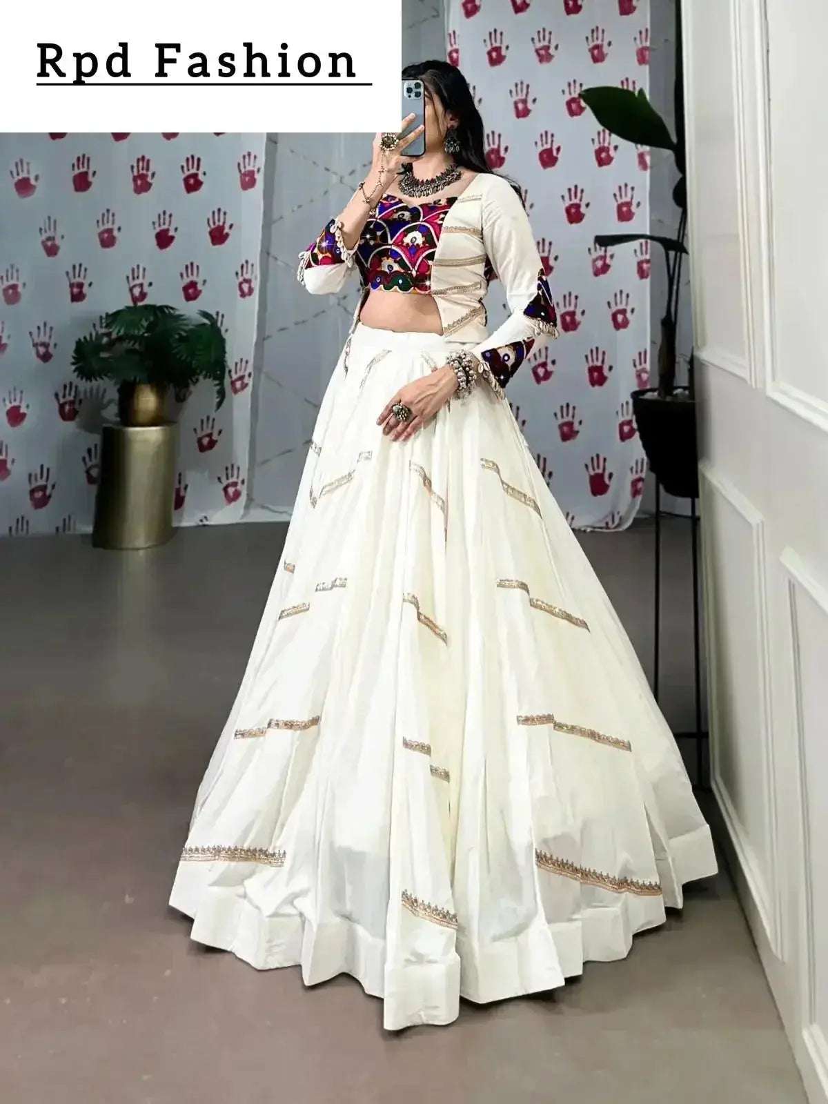 A woman in a flowing white cstands against a wall, emphasizing her elegant style and the dress's design - RPD Fashion