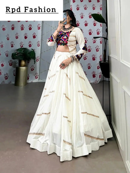 A woman in a flowing white cstands against a wall, emphasizing her elegant style and the dress's design - RPD Fashion