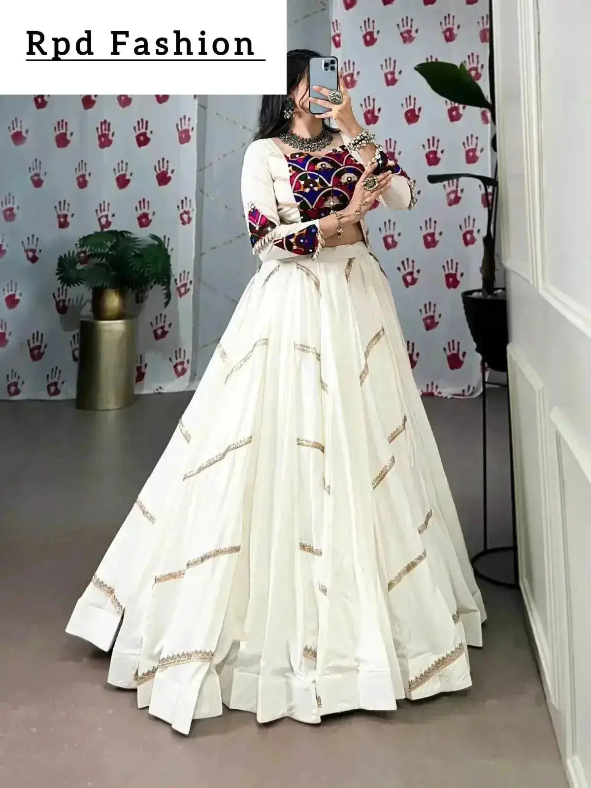 A woman in a flowing white cstands against a wall, emphasizing her elegant style and the dress's design - RPD Fashion