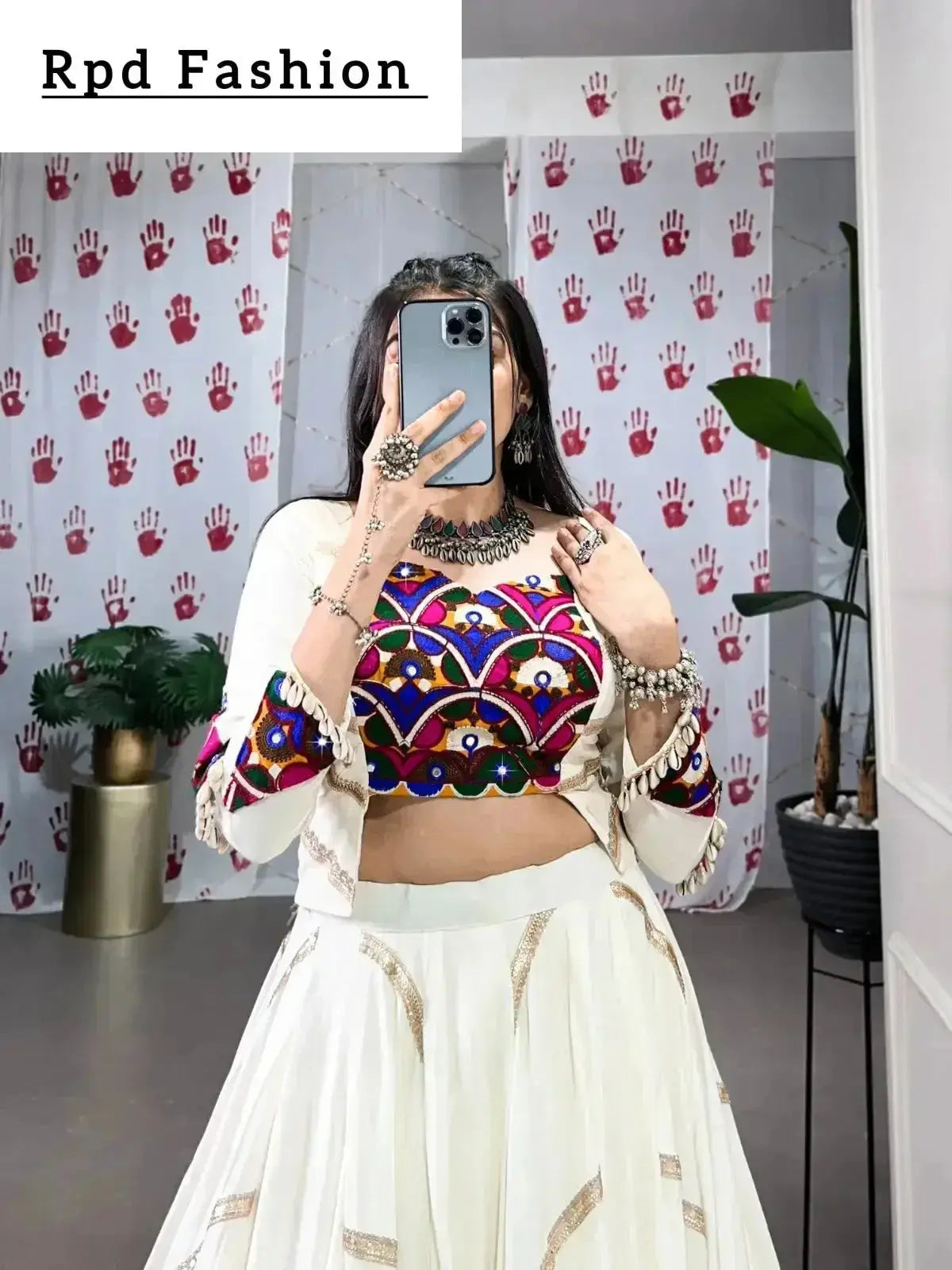 A woman in a flowing white cstands against a wall, emphasizing her elegant style and the dress's design - RPD Fashion