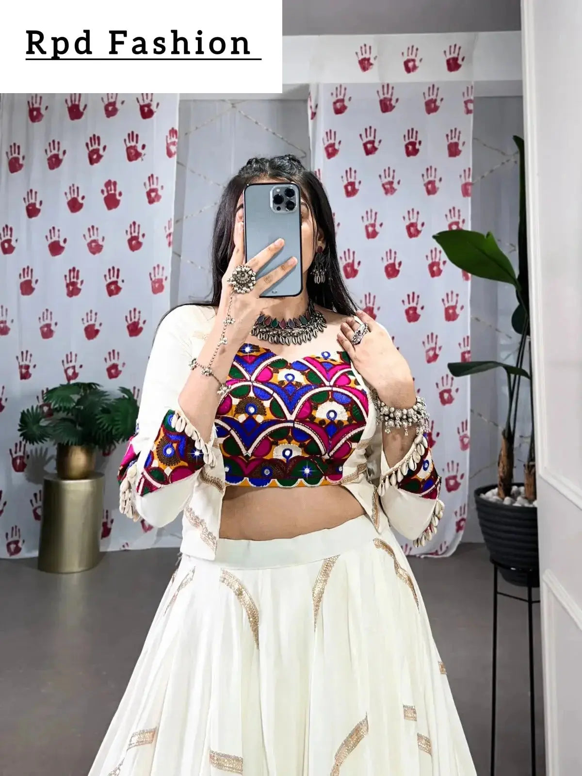 a woman in a flowing white cstands against a wall, emphasizing her elegant style and the dress's design - rpd fashion