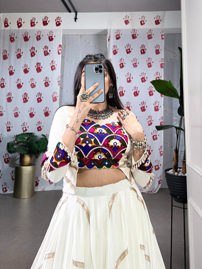 A woman in a flowing white cstands against a wall, emphasizing her elegant style and the dress's design Rpd Fashion