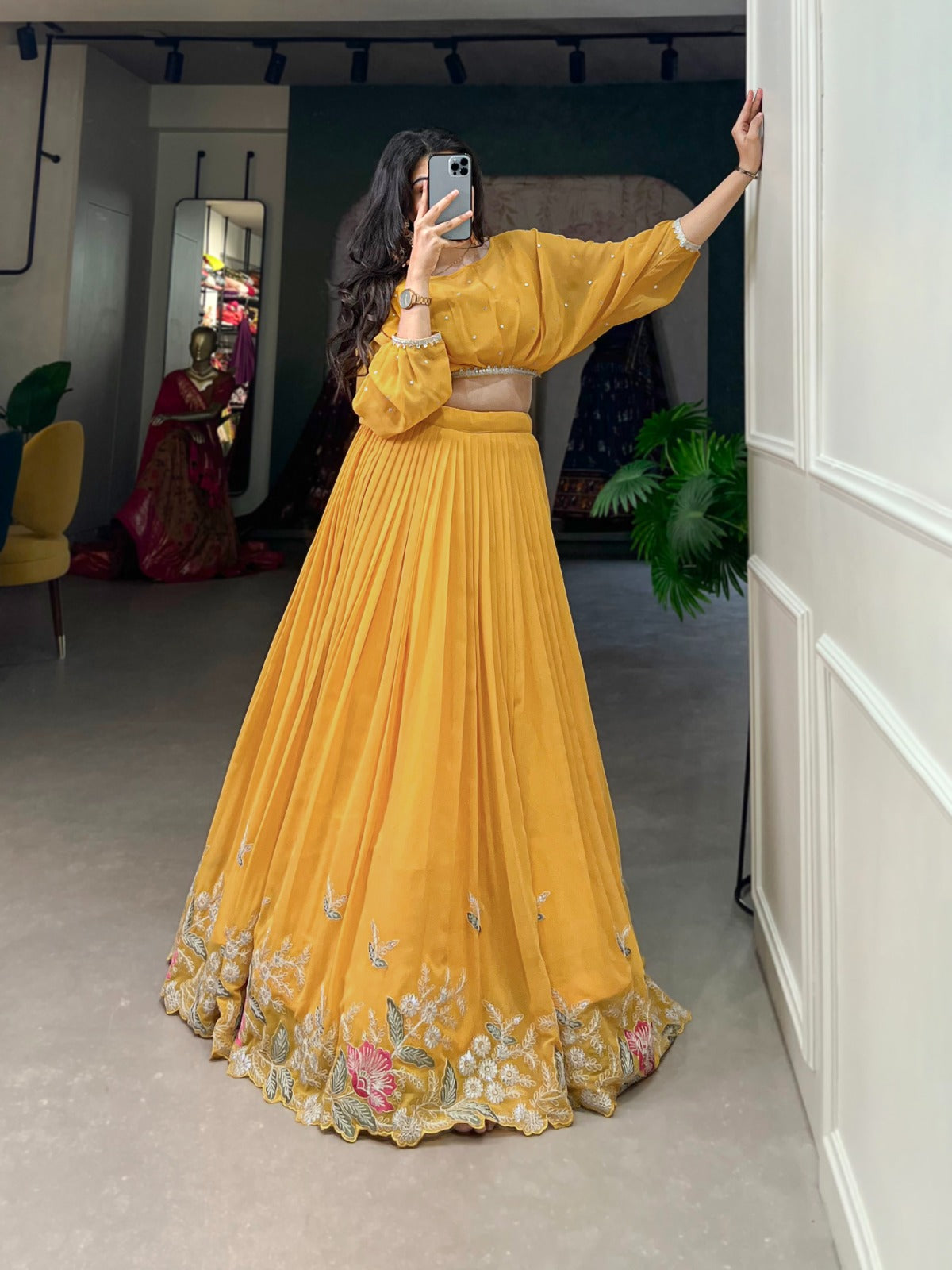 this stitched lehenga set includes georgette fabric with sequin-thread embroidery and a matching top with beautiful lace-bordered sequin butties.