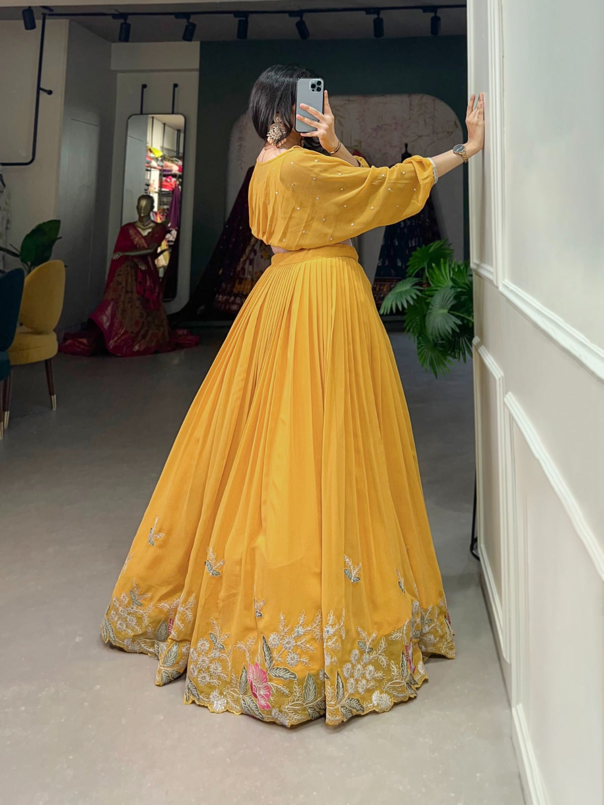 this stitched lehenga set includes georgette fabric with sequin-thread embroidery and a matching top with beautiful lace-bordered sequin butties.